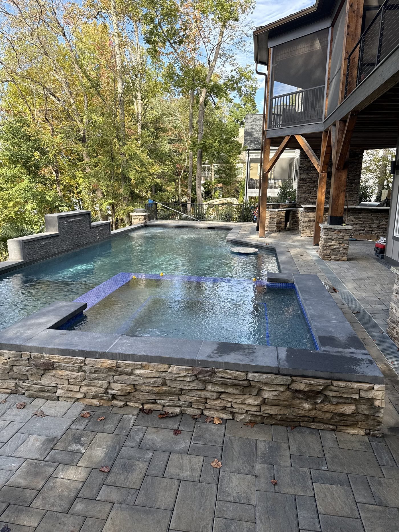 Completed pool with stone coping and spa