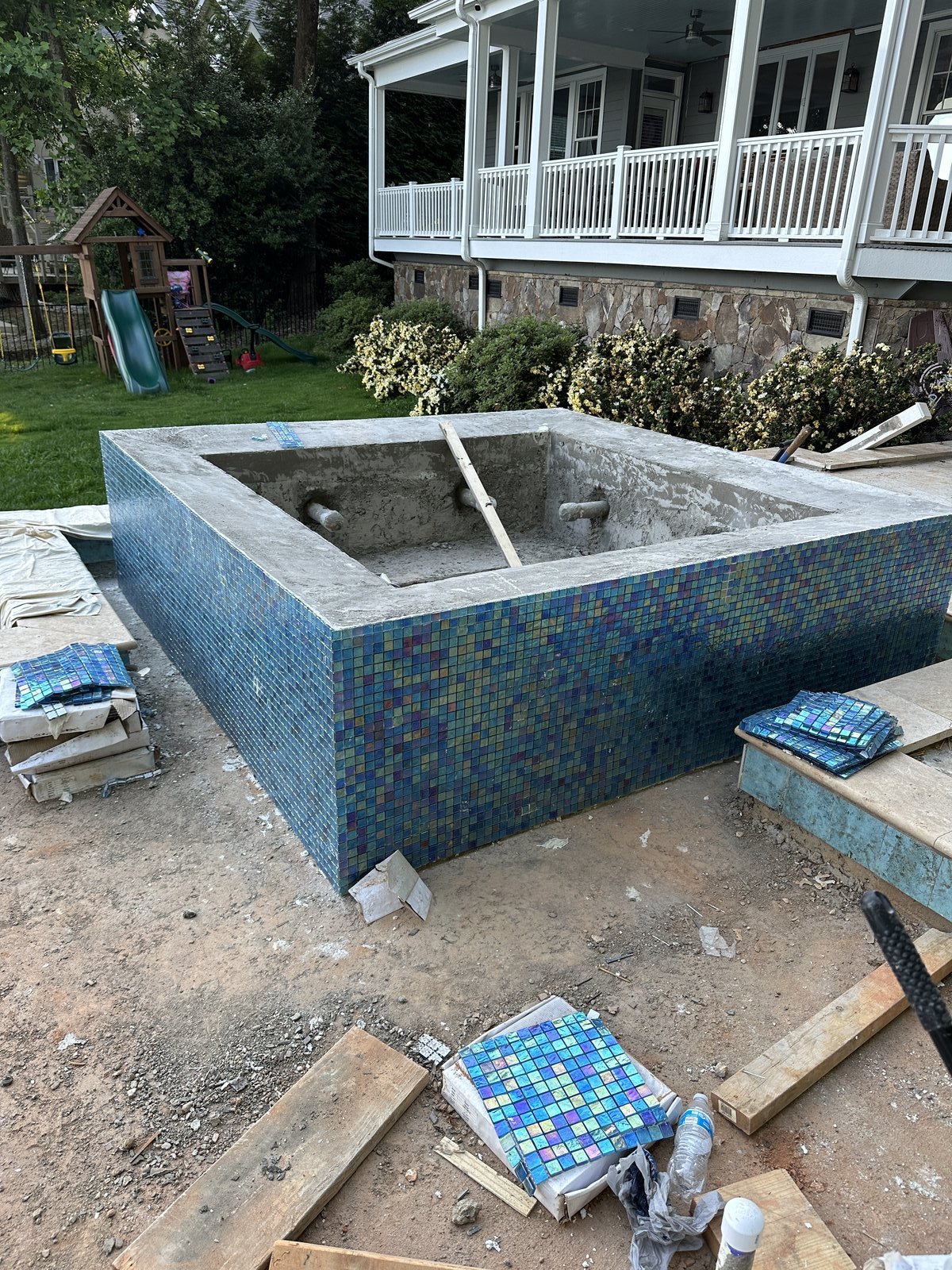 Iridescent glass tile and coping installation