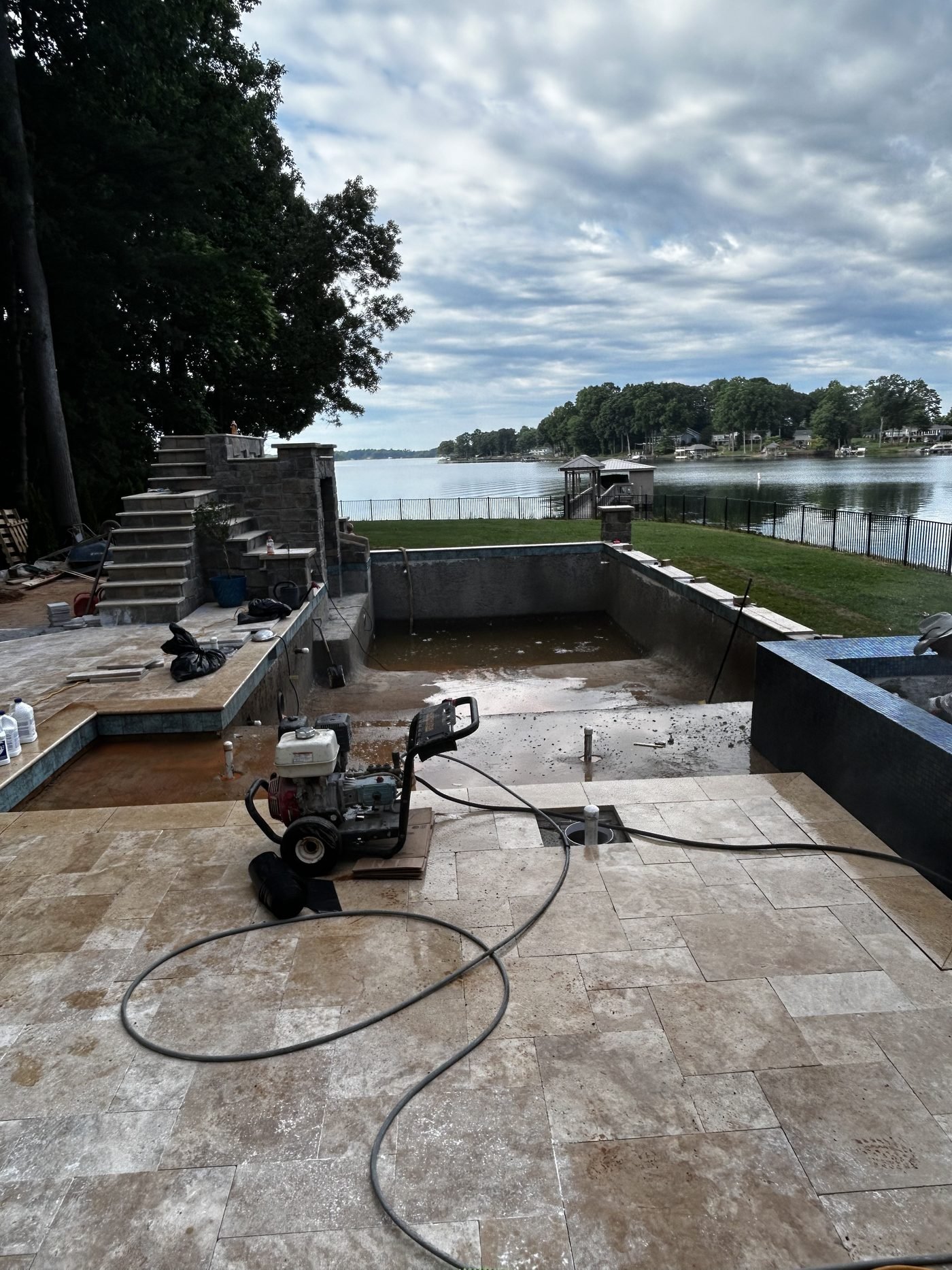 Lakefront pool construction with Lake Norman backdrop